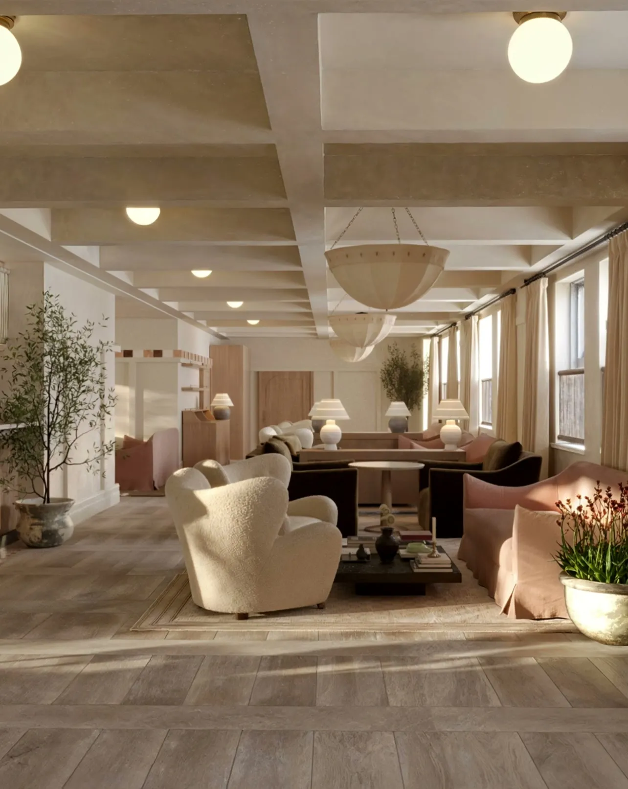 The same lounge with materials and furnishings now in place — warm stone flooring, boucle and velvet seating, pendant lighting and planting — styling still being refined.
